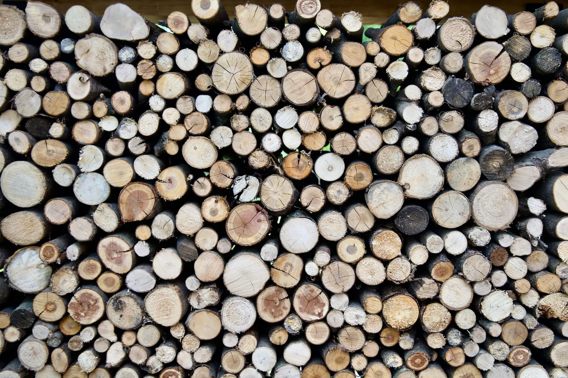 Detail krásně naskládaných polen v ocelovém rámu